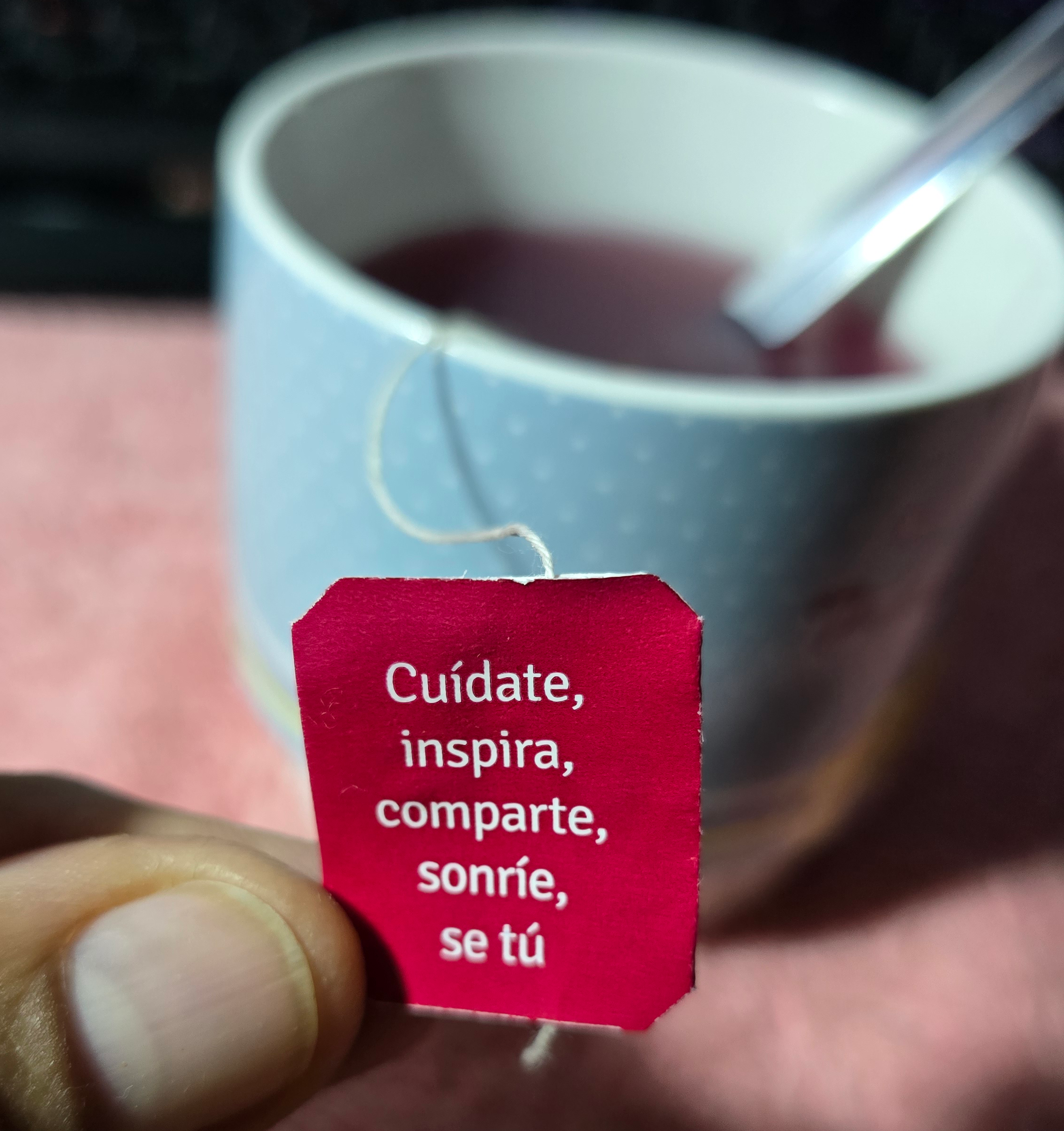Tea cup with label reading 'Care, Inspire, Share, Smile, Be Yourself'